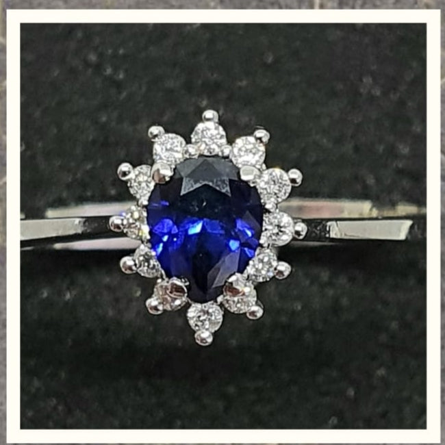0.40cts Pear Cut Diffused Sapphire | 0.10cts [12] Round Brilliant Cut Diamonds | Designer Ring | 14kt White Gold