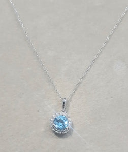 0.75ct Round Cut Blue Topaz | 0.10cts Round Brilliant Cut Diamonds | Halo Design Pendant and Chain | 14kt White Gold