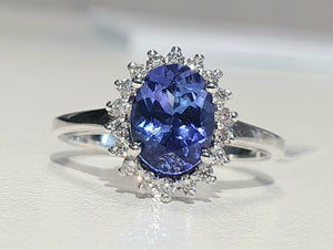 1.70ct Oval Cut Tanzanite Centre | 0.20cts [18] Round Brilliant Cut Diamonds | Halo Design Ring | 9kt White Gold