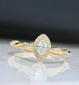 0.17ct Marquise Cut Diamond | 0.150cts [34] Round Brilliant Cut Diamonds | Twist Design Ring | 18kt Yellow Gold